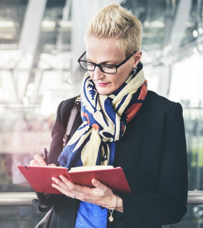 businesswoman writing waiting flight concept PA72YZ6