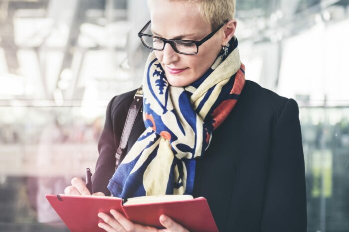 businesswoman writing waiting flight concept PA72YZ6