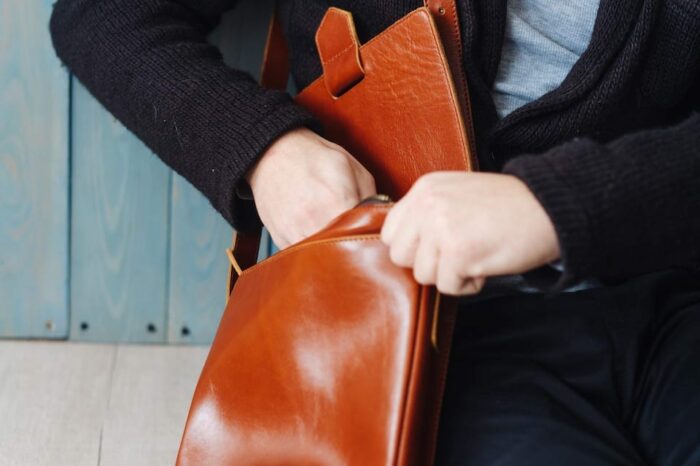 handsome guy with leather bag YXUVNZK