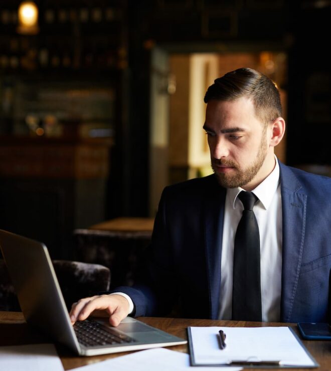 busy man using laptop in cafe PX5GAKJ