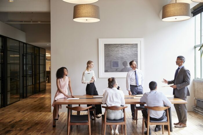 young professionals around a table at a business PRK39CZ